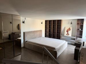a bedroom with a large bed and a mirror at Luxury flat 2 in Pleven