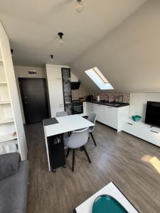 a kitchen and living room with a table and a couch at Luxury flat 2 in Pleven