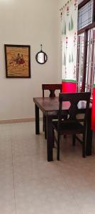 a wooden table and a bench in a room at Tara pushkar in Pushkar