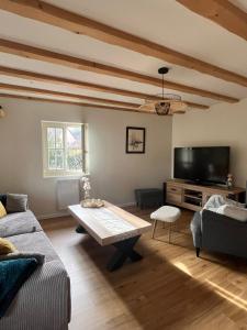 a living room with a couch and a coffee table at La cour du vigneron in Turckheim