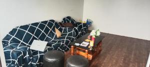 a living room with a couch and a table at Mamta's Homestay in Aritar