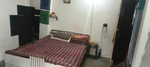 a bedroom with a bed in a room at Mamta's Homestay in Aritar
