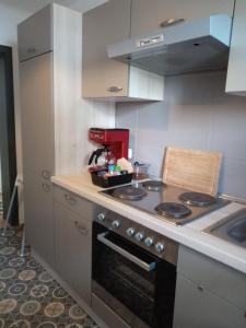 a small kitchen with a stove and a sink at Ferienwohnung Schimpf in Sosberg