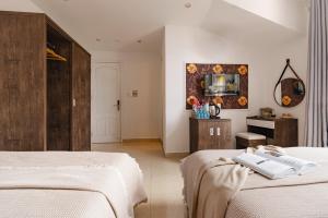 a hotel room with two beds and a tv at GreenMeadow Central Boutique in Da Lat