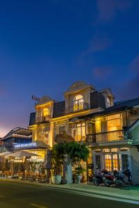 a building with a motorcycle parked in front of it at GreenMeadow Central Boutique in Da Lat