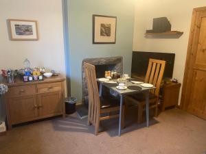 a dining room with a table and two chairs at Garth Engan B&B with private lounge in Llanbedr