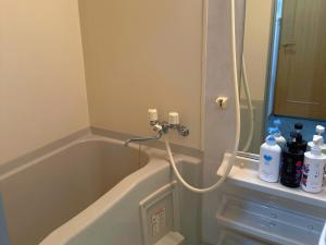 a bathroom with a bath tub with a shower at 星の宿大阪城 in Osaka