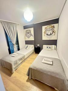 a room with two beds in a room at Marin Beach Apartments Patacona in Valencia +72 photos