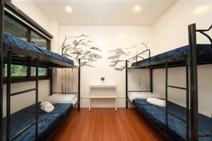a room with two bunk beds and a desk at 3BR The South Drive Loft 301 in Baguio