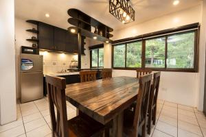 a large kitchen with a wooden table and chairs at 3BR The South Drive Loft 301 in Baguio