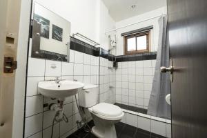 a white bathroom with a toilet and a sink at 3BR The South Drive Loft 301 in Baguio +9 photos