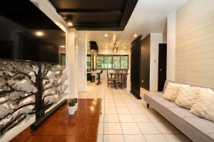 a living room with a couch and a table at 3BR The South Drive Loft 301 in Baguio