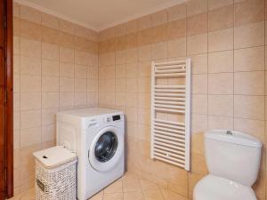 a bathroom with a washing machine and a toilet at Casa Horizon in Palaiochora +49 photos