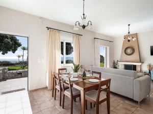 a living room with a table and a couch at Casa Horizon in Palaiochora