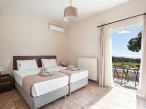 a bedroom with a bed and a large window at Casa Horizon in Palaiochora