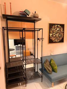 a room with a glass shelf and a couch at Boho ElTha Lotus in Patra