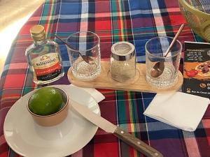 a table with a plate with a lime and glasses at Vi la dous Kreyol in Sainte-Rose +2 photos