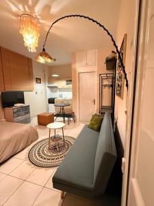 a living room with a couch and a kitchen at Boho ElTha Lotus in Patra