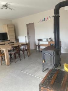 a living room with a wood stove and a table at Escale in La Motte-Servolex