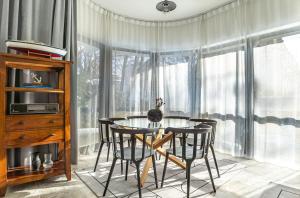 a dining room with a glass table and chairs at Baltivia Haus II in Gdynia