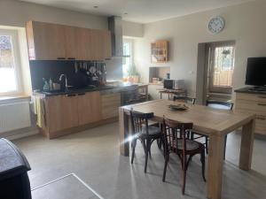 a kitchen with a wooden table and chairs in it at Escale in La Motte-Servolex
