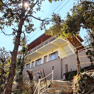 a house with stairs leading up to it at Meru Stays - A Kumaouni Homestay in Mukteshwar