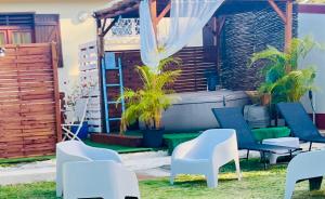 a patio with chairs and a hot tub at Vi la dous Kreyol in Sainte-Rose