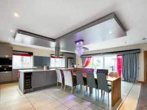 a kitchen and dining room with a table and chairs at The Wendover in Rowen