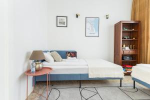 a bedroom with a bed and a table at Baltivia Haus II in Gdynia