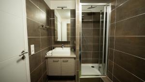 a bathroom with a sink and a shower at Sky One La Defense in Courbevoie