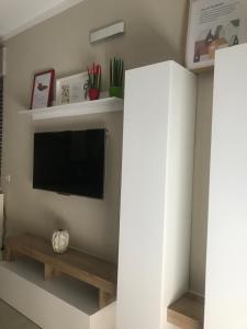 a living room with a tv and shelves at La piccola Balilla in Venosa