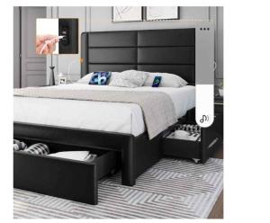 a bedroom with a large black bed with two drawers at Nuria luxurious one bed room apartment in Sekondi-Takoradi