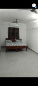 a couch sitting in a room with a window at Akshay Hotel in Bikaner