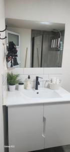 a white bathroom with a sink and a mirror at שקט בערבה in Sappir +11 photos
