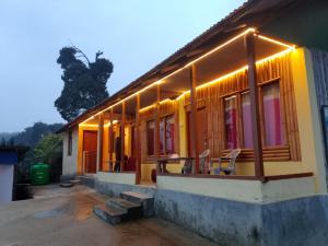 a house with lights on the side of it at Meghh Minar Homestay Sillery Gaon in Kalimpong