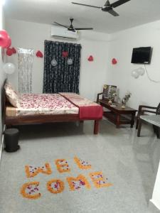 a bedroom with a bed with a sign on the floor at Akshay Hotel in Bikaner