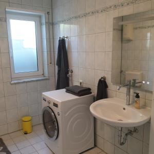 a bathroom with a washing machine and a sink at Ferienwohnung Stefanie am Frankenbach in Bad Breisig