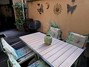 a wooden table and chairs with a vase on it at GuestHouse Groenplaats in Antwerp