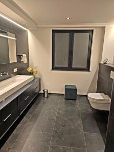 a bathroom with a sink and a toilet at GuestHouse Groenplaats in Antwerp +14 photos