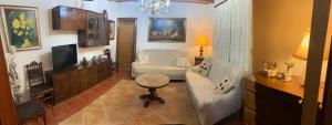 a living room with a couch and a chair at Villa Conde, Piscina, Barbacoa y Gran Patio in Prado