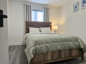 ein Schlafzimmer mit einem großen Bett und einem Fenster in der Unterkunft Elegant 3-bedroom Home Away From Home, Luxury Styled in St. John's