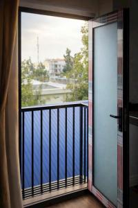 an open door to a balcony with a view at Vũ Ngọc Hotel Núi Sam in Chau Doc
