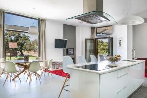a kitchen and dining room with a table and chairs at Villa Katrin in Svoronata