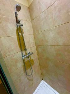 a shower with a glass door and a toilet at Babo room in Farnworth +1 photo