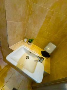 a bathroom with a sink and a shower at Babo room in Farnworth