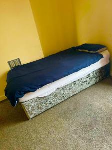 a bed in a corner of a room at Babo room in Farnworth