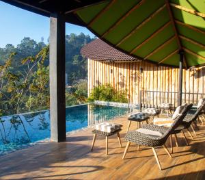 a deck with chairs and a swimming pool at O2 Villas Ella in Ella
