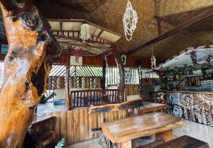 a room with benches and a table in a cabin at Hot Chilli Hotel in Tuktuk Siadong