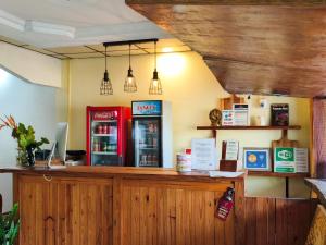 a counter with two soda machines in a restaurant at Hostel, Café & Garden Travelers in Santiago