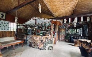 a restaurant with a counter and a bench in a room at Hot Chilli Hotel in Tuktuk Siadong
